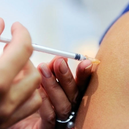 A woman receives a vaccination