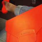 Khloe Kardashian with orange Givenchy clutch bag