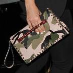 Kim Kardashian with camouflage print Valentino clutch