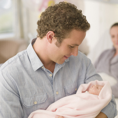 Dad holding new born baby