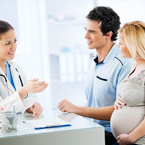Pregnant couple speaking with doctor