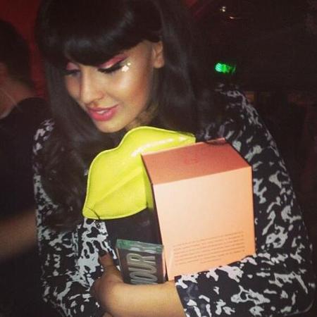 Jameela Jamil with yellow Lulu Guinness clutch bag