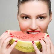 Woman eating a slice of watermelon