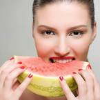 Woman eating a slice of watermelon