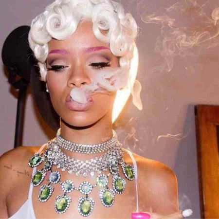 Rihanna wearing white blonde wig and purple eye brows