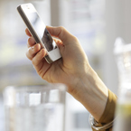 Woman's hand holding a mobile phone - health and fitness apps - handbag.com