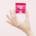 Women holding a condom - contraception methods - protection - condoms - women's health - advice - handbag.com